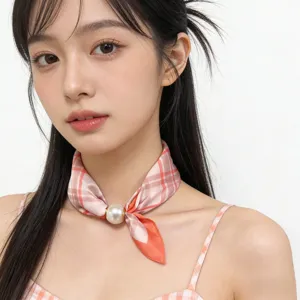 Closeup detail of the stylish pink plaid neck scarf with an elegant magnetic pearl buckle.