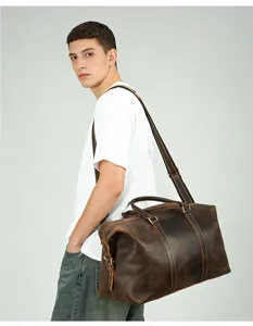 Close-up detail of the vintage leather travel duffel bag showing fine stitching and strap.