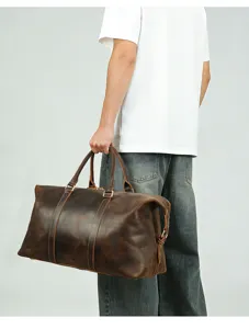 Detail view of men's genuine leather travel duffel bag, large capacity, vintage brown finish.