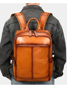 Detailed rear view of brown leather backpack showcasing vintage texture and durable straps.
