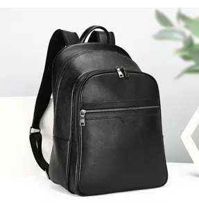 Detailed shot of black leather backpack zipper and pebble texture craftsmanship in studio.