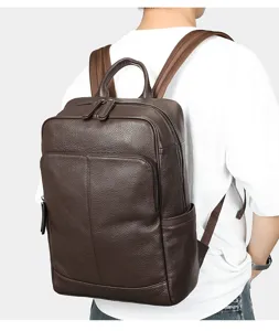 Detail view of brown leather men's backpack, worn on back, casual business style, durable.