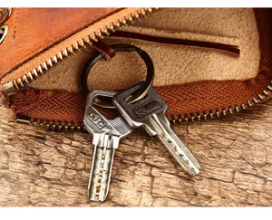 Genuine leather zipper key pouch coin purse with metal ring and keychain detail photo.