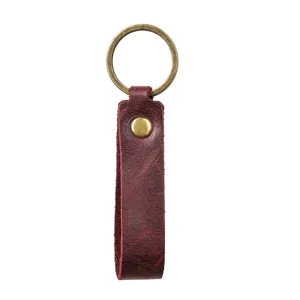Vue détaillée du porte-clés en cuir véritable avec anneau en métal bronze solide.