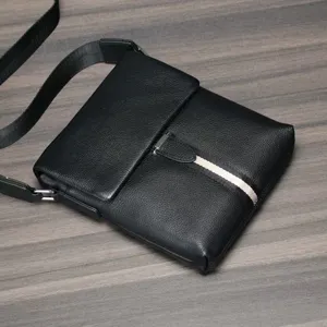 Black genuine leather men's crossbody bag with vertical stripe detail and flap closure.