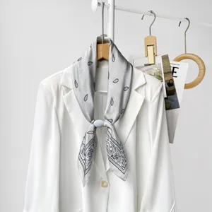 Minimalist grey paisley silk scarf with magnetic buckle, elegant women's neckerchief detail.