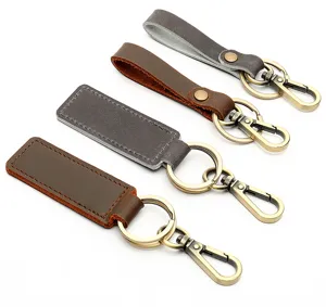 Close-up detail showing retro crazy horse leather car keychains with bronze metal clasps.
