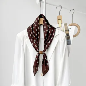 Chic brown polka dot silk scarf for women, elegant commuter neckerchief detail.