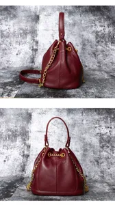 Wine red leather bucket bag detail with gold chain strap and top handle design.