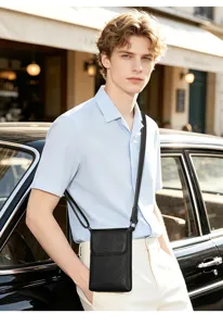 Detail shot of men's black genuine leather cross-body phone bag, featuring fine pebbled texture.