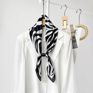 Zebra print silk scarf detail view, elegant black and white pattern for women commute style.