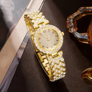 Detail of luxurious gold women's quartz watch fully encrusted with clear rhinestones