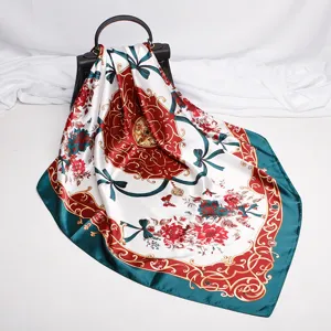 Close-up of luxury satin silk scarf featuring elegant baroque floral print and rich vintage colors.