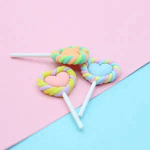 Close-up of colorful pastel heart marshmallow lollipop polymer clay DIY jewelry charms