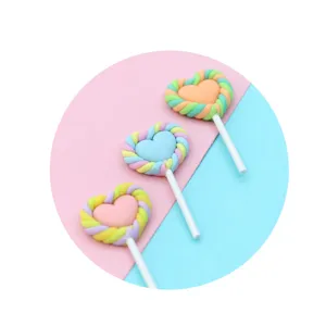 Detailed view of handmade pastel heart-shaped clay lollipop charms for DIY accessories