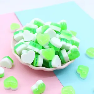 Detailed macro view of green heart-shaped resin charms for DIY slime and craft decoration
