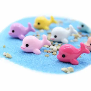 Macro close-up of colorful resin dolphin miniatures for DIY ocean micro-landscape decor