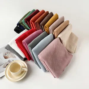 Detailed view of colorful pleated solid scarves available in various elegant shades and textures