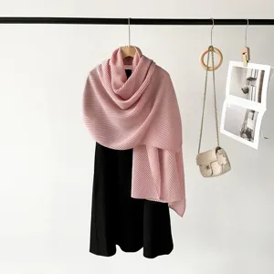 Close-up detail of a soft pink pleated scarf featuring a delicate fabric texture and elegant drape