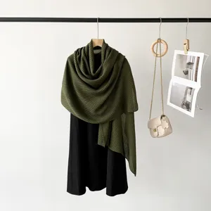 Detailed view of olive green pleated shawl elegantly draped in a lifestyle setting