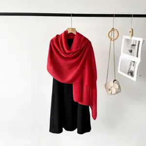 Close-up detail of a vibrant red pleated scarf featuring delicate organ pleat texture