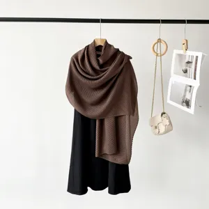 Close-up view of a long brown pleated scarf for women with elegant crinkle texture
