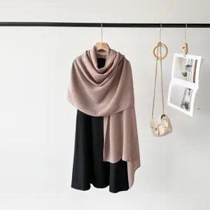 Macro view of pleated mauve silk-feel scarf with elegant texture for women's fashion