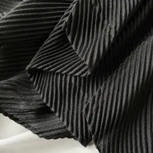 Detailed close-up showing the fine pleated texture of a black solid color scarf.