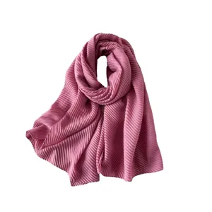Elegant dusty pink pleated scarf with delicate linear texture shown on white background.