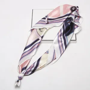 Silk satin square scarf detail showcasing elegant equestrian harness print and smooth texture.