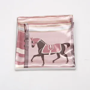 Pink satin silk square scarf detail showing elegant equestrian horse print and stripe pattern design.