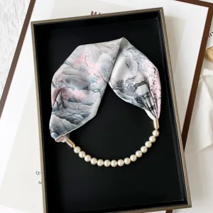 Exquisite floral print scarf with pearl magnetic clasp necklace, elegant women's fashion accessory detail.