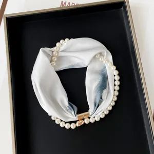 Detail view of stylish pearl necklace silk scarf with magnetic clasp for women fashion outfits.