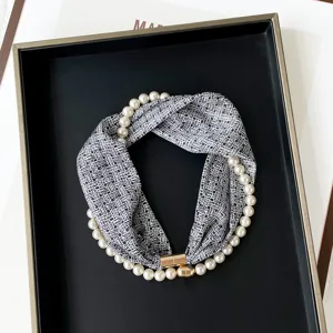 Chic black and white printed silk scarf with elegant pearl necklace and golden magnetic clasp.