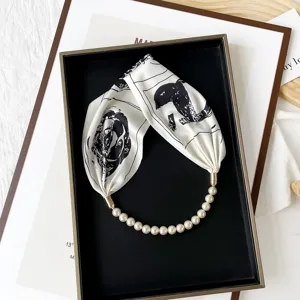 Chic black and white printed silk scarf necklace with elegant pearl strand and magnetic clasp.