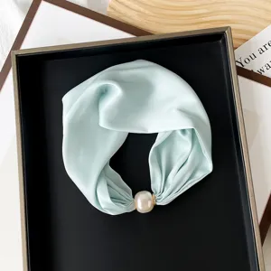 Detailed shot of mint green silk scarf with large pearl magnetic clasp neckerchief.
