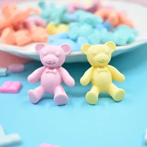Close-up detail of cute matte resin bear accessories in pastel pink and yellow