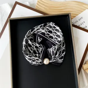 Black and white monogram print small silk scarf with elegant pearl magnetic buckle accessory.