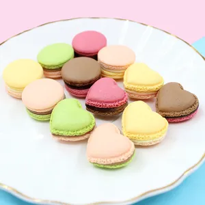 Detailed macro shot of colorful heart and round 3D macaron resin charms for DIY crafts.