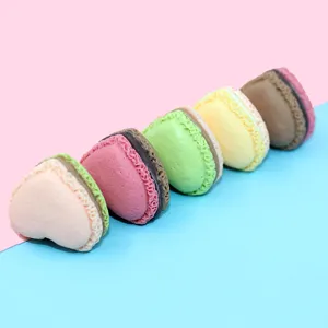 Close-up of heart-shaped macaron resin DIY craft accessories in vibrant pastel colors.