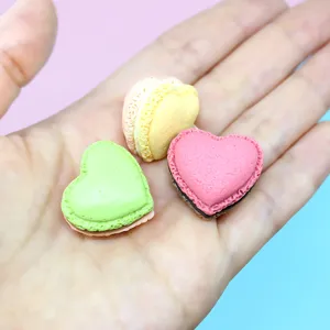 Detailed close-up of colorful heart-shaped macaron resin charms for DIY craft projects