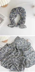 Detail view of the blue paisley cotton linen small square scarf showing fabric texture and print.