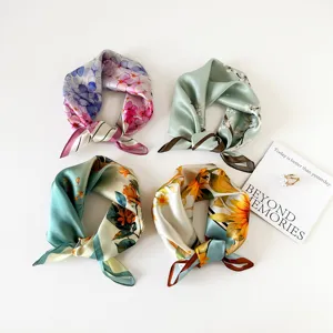 Detailed shot of mulberry silk floral square scarf featuring four vibrant color variants.