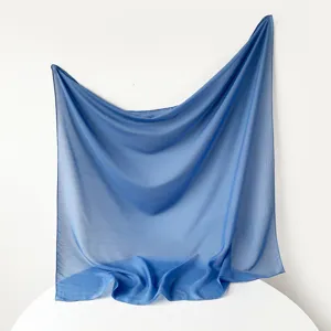Solid color Turkish gauze square scarf, lightweight breathable blue hijab accessory detail.