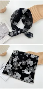 Vista dettagliata di un foulard in cotone e lino con stampa floreale e raffinato bordo in pizzo.