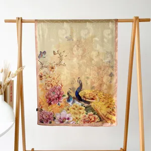 Detailed view of a luxurious satin silk scarf featuring vibrant peacock and floral print.
