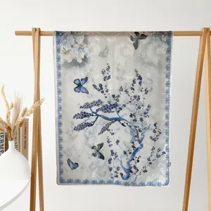 blue and white floral print silk scarf detail view with elegant butterfly pattern