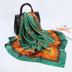 Detailed view of 90cm silk satin scarf with luxury chain and horse bit print design.