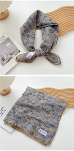 Primo piano di foulard quadrato in cotone e lino grigio con stampa floreale gialla e pizzo.
