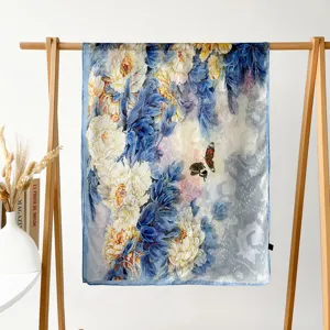 Detail view of a floral print silk scarf hanging on a wooden rack, elegant and soft.